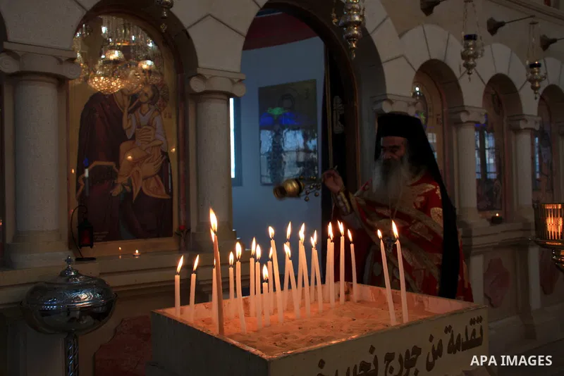 Palestinian Greek Orthodox worshipers attend Christmas services at a Greek Orthodox church in the West Bank city of Nablus, Friday, Jan. 7, 2011. Christmas falls on Jan. 7 for Orthodox Christians in Eastern Orthodox chur...