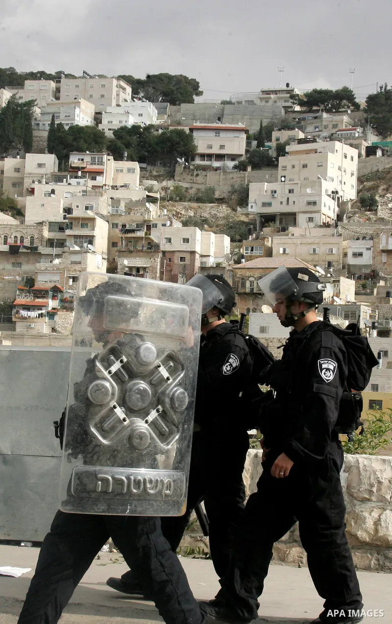 Israeli policemen stand guard during clashes with Palestinian youths in the Arab east Jerusalem neighbourhood of Silwan against Jewish settlement activity in the Palestinian districts of the holy city on Jan. 7, 2011. Ph...