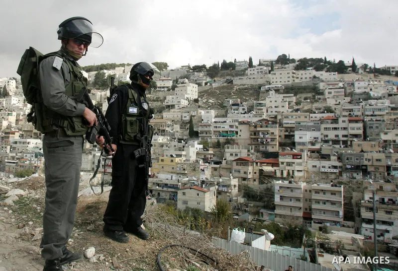 Israeli policemen stand guard during clashes with Palestinian youths in the Arab east Jerusalem neighbourhood of Silwan against Jewish settlement activity in the Palestinian districts of the holy city on Jan. 7, 2011. Ph...