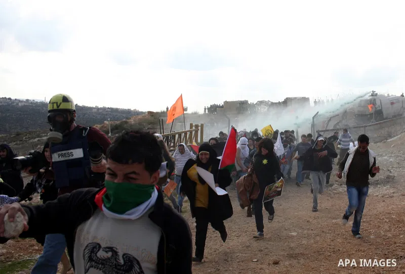 Isareli soldiers disperse protesters in the village of Bilin on January 7, 2011. Israeli troops in Hebron shot dead an elderly Palestinian civilian on Friday in a case of mistaken identity as they searched for a Hamas pr...