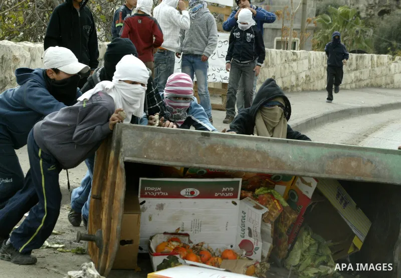 Palestinian youths hurl stones towards Israeli soldiers during clashes with Palestinian youths in the Arab east Jerusalem neighbourhood of Silwan against Jewish settlement activity in the Palestinian districts of the hol...