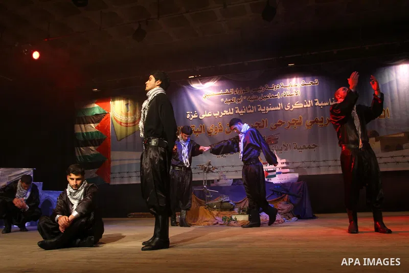 Palestinian youths perform the traditional dance Dabka during a celebration to honor Palestinian disabled who injured during the Israeli war on Gaza Strip 2008-2009 on the second anniversary of the war, in Gaza city on J...