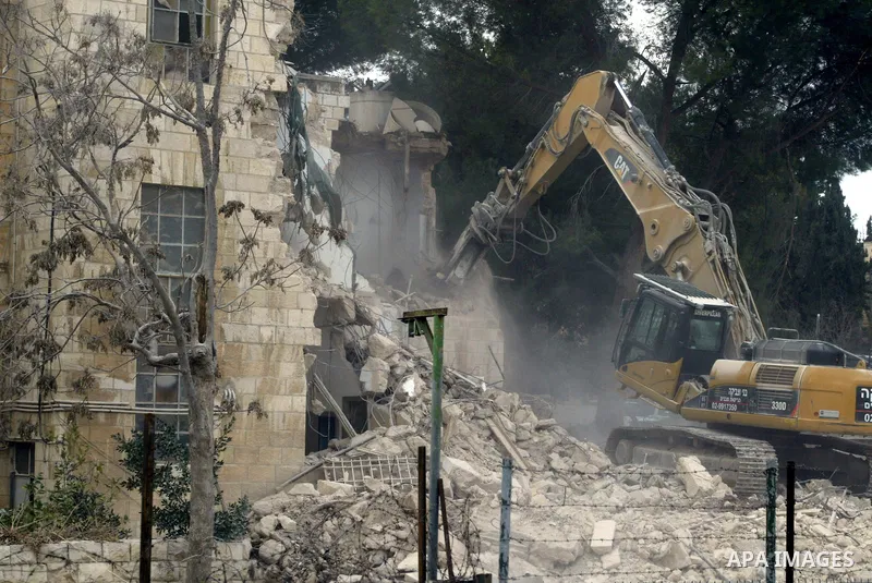 An Israeli bulldozer demolishes Shepherd hotel in the Sheikh Jarrah neighborhood in East Jerusalem on Jan. 9, 2011. Photo by Mahfouz Abu Turk
