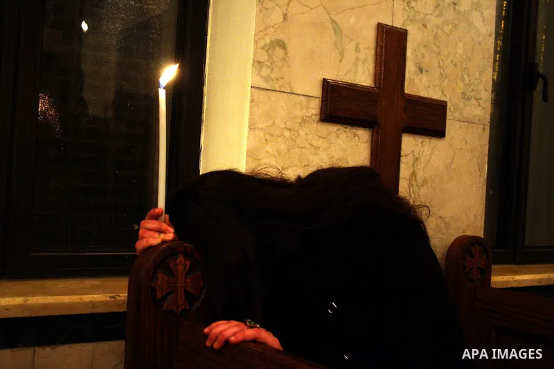 Palestinian Christians light candles at the Copts church in the West Bank city of Ramallah on January 9, 2011 to .A powerful bomb, possibly from a suicide attacker, exploded in front of a Coptic Christian church in Alexa...