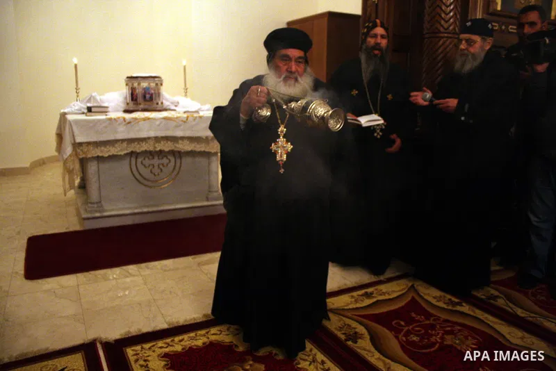 Palestinian Christians light candles at the Copts church in the West Bank city of Ramallah on January 9, 2011 to .A powerful bomb, possibly from a suicide attacker, exploded in front of a Coptic Christian church in Alexa...