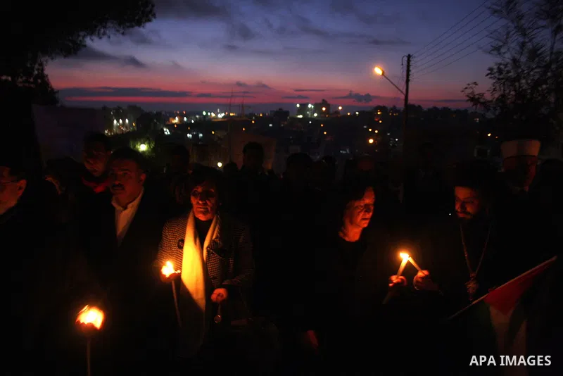 Palestinian Christians light candles at the Copts church in the West Bank city of Ramallah on January 9, 2011 to .A powerful bomb, possibly from a suicide attacker, exploded in front of a Coptic Christian church in Alexa...
