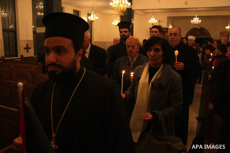 Palestinian Christians light candles at the Copts church in the West Bank city of Ramallah on January 9, 2011 to .A powerful bomb, possibly from a suicide attacker, exploded in front of a Coptic Christian church in Alexa...