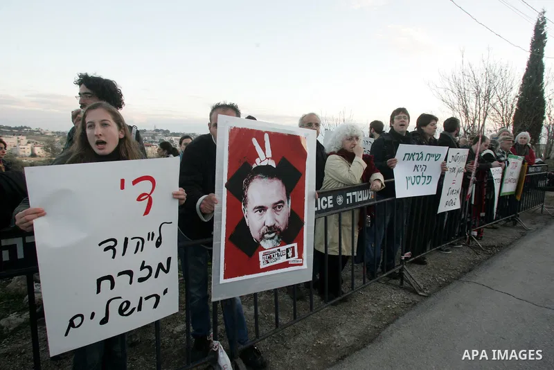 Demonstrators protest across the street from what remains of the Shepherd Hotel in the Sheikh Jarrah neighborhood in East Jerusalem during a protest against Jewish settlement of Arab East Jerusalem following the building...