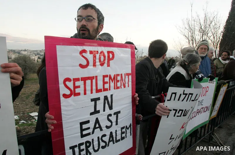 Demonstrators protest across the street from what remains of the Shepherd Hotel in the Sheikh Jarrah neighborhood in East Jerusalem during a protest against Jewish settlement of Arab East Jerusalem following the building...