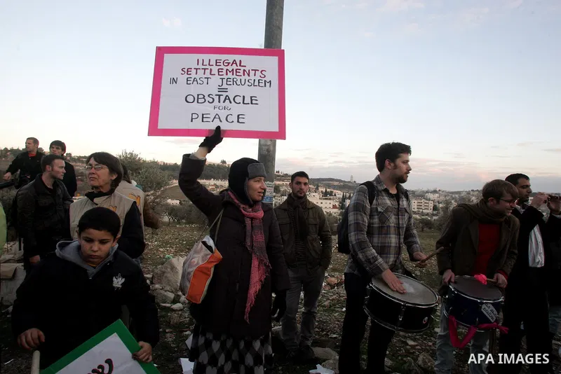 Demonstrators protest across the street from what remains of the Shepherd Hotel in the Sheikh Jarrah neighborhood in East Jerusalem during a protest against Jewish settlement of Arab East Jerusalem following the building...