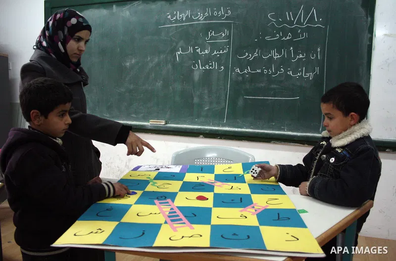 Palestinian students take part during a lesson to get an assistance in education, in basic school, in the West Bank city of Hebron on January 10, 2011. Photo by Najeh Hashlamoun