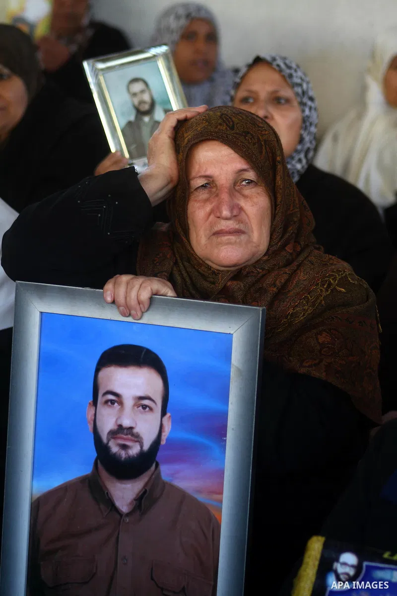A Palestinian women holds picture of jailed relative during a protest calling for the release of Palestinian prisoners from Israeli jails at the Red Cross office in Gaza City on Jan. 10,2011. Photo by Ashraf Amra
