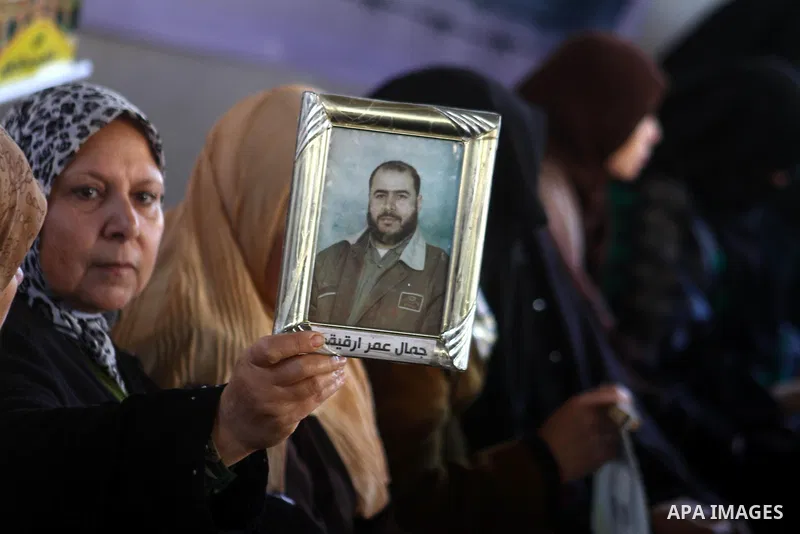 Palestinian women hold pictures of jailed relatives during a protest calling for the release of Palestinian prisoners from Israeli jails at the Red Cross office in Gaza City on Jan. 10,2011. Photo by Ashraf Amra