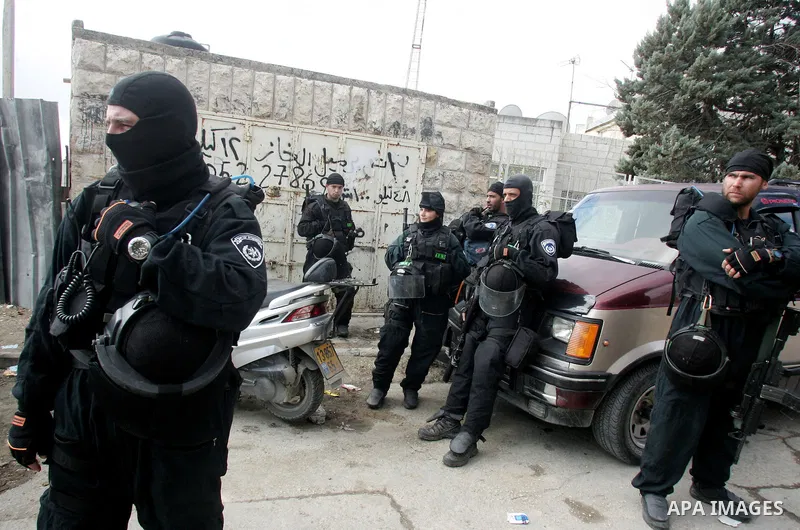 Israeli soldiers take position during a demolishing to horse stable for a Palestinian as Israeli army say that the stable was built without a construction permit, in the Arab Jerusalem neighborhood of Wadi al-Joz, on Jan...