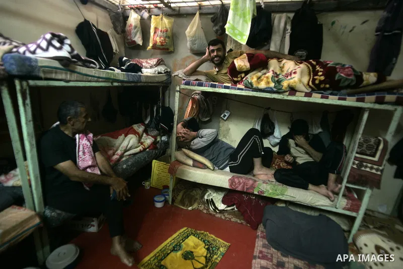 Palestinian inmates sit inside a cell at a prison controlled by the Hamas police in the southern Gaza Strip town of Khan Younis on Jan. 9, 2011. According to Hamas police, number of prisoners accused of spying for the Is...
