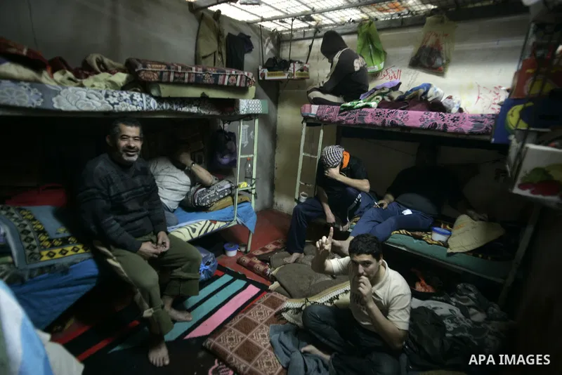 Palestinian inmates sit inside a cell at a prison controlled by the Hamas police in the southern Gaza Strip town of Khan Younis on Jan. 9, 2011. According to Hamas police, number of prisoners accused of spying for the Is...