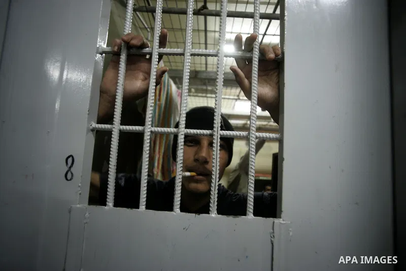 A Palestinian inmate smokes inside a cell at a prison controlled by the Hamas police in the southern Gaza Strip town of Khan Younis on Jan. 9, 2011. According to Hamas police, number of prisoners accused of spying for th...