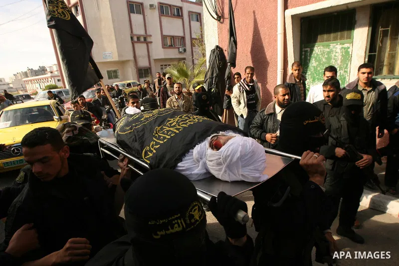 Palestinian militants from the Islamic Jihad carry the body of Mohamed al-Najjar, who was killed during an Israeli air strike the previous day, during his funeral in Khan Yunis, southern Gaza Strip, on January 12, 2011....