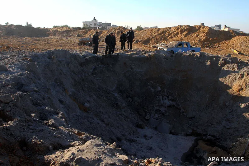 Palestinian Hamas police officers survey the damage after an Israeli air strike on a Hamas security compound in al-Nuseirat refugee camp in the central Gaza Strip January 12, 2011. Security officials said three air strik...