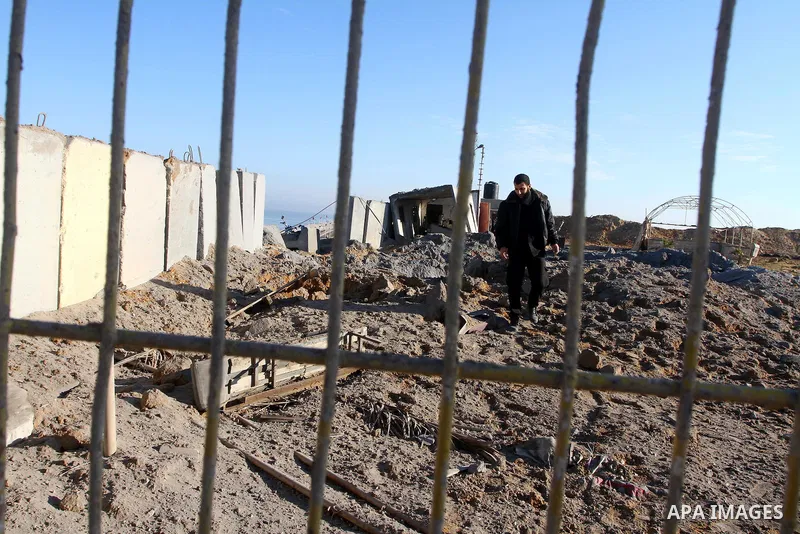 A Palestinian Hamas police officer inspects the damage after an Israeli air strike on a Hamas security compound in al-Nuseirat refugee camp in the central Gaza Strip January 12, 2011. Security officials said three air st...