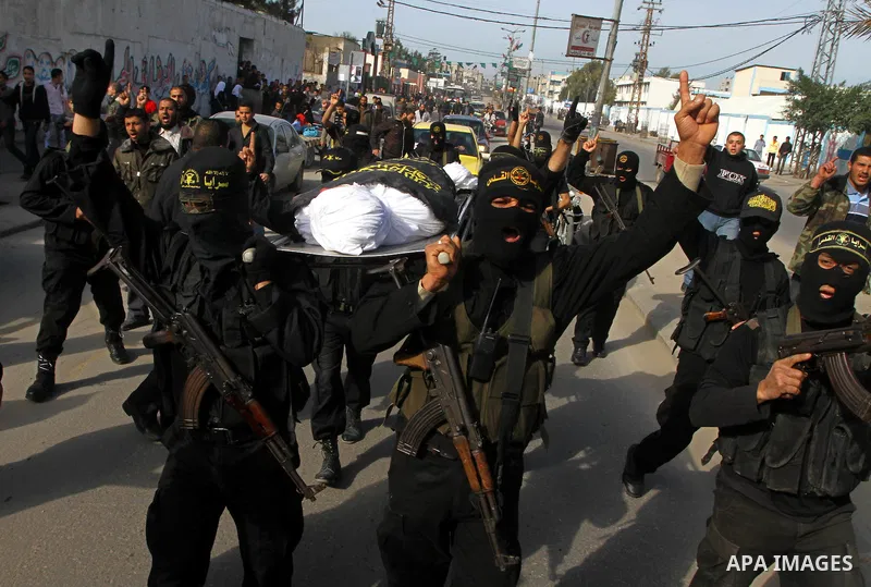 Palestinian militants from the Islamic Jihad group carry the body of their comrade Mohammed Najjar during his funeral in Khan Younis in the southern Gaza Strip on January 12, 2011. A missile fired by an Israeli aircraft...