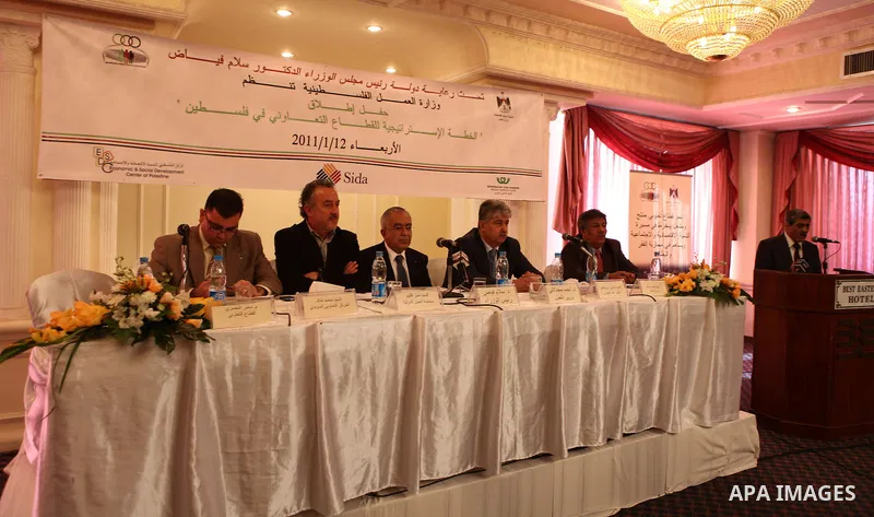 Palestinian Prime Minister Salam Fayyad attends a conference about launching a plan of improving the conditions of cooperative societies, in the West Bank city of Ramallah on Jan. 12, 2011. Photo by Mustafa Abu Dayeh