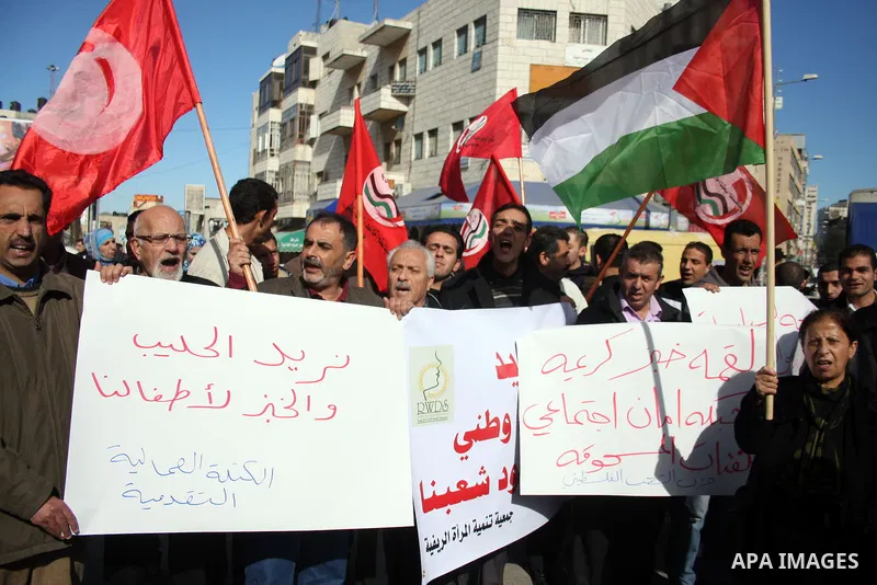 Palestinians take part in a protest against prices rising and high taxes in the West Bank city of Ramallah on Jan. 12, 2011. Fuel prices rises 5% as more than 150,000 Palestinian families considers under the poverty line...