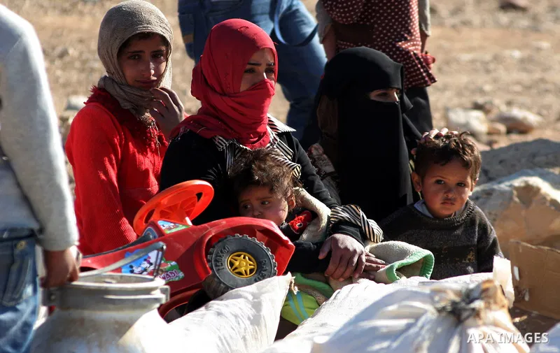 Palestinians bedouin sit on their belongings as Israeli bulldozers demolish their house in the West Bank village of Yatta near Hebron on Jan. 12, 2011. Israeli Army pulled down Wednesday an elementary school and 17 homes...