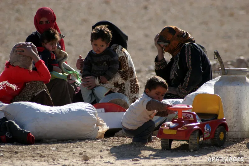 Palestinians bedouin sit on their belongings as Israeli bulldozers demolish their house in the West Bank village of Yatta near Hebron on Jan. 12, 2011. Israeli Army pulled down Wednesday an elementary school and 17 homes...
