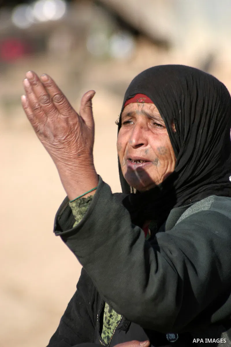 Palestinians bedouin sit on their belongings as Israeli bulldozers demolish their house in the West Bank village of Yatta near Hebron on Jan. 12, 2011. Israeli Army pulled down Wednesday an elementary school and 17 homes...