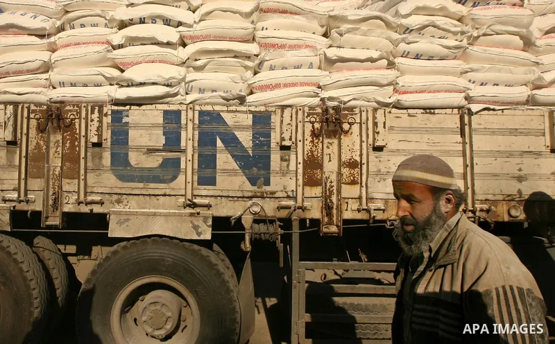 Palestinian man walks past an UN distribution car at the refugee camp of Rafah in the southern Gaza Strip on January 13, 2011. The UN distribution center is one of many in the Gaza strip and distributes between 25 and 38...