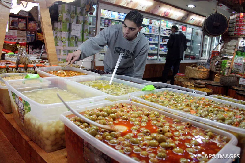 Palestinians display their goods at a food store in the West Bank city of Hebron on January 13, 2011. Photo by Najeh Hashlamoun