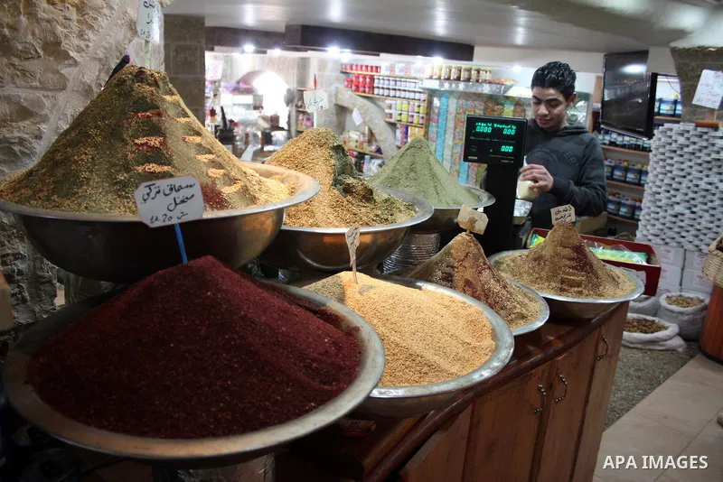 Palestinians display their goods at a food store in the West Bank city of Hebron on January 13, 2011. Photo by Najeh Hashlamoun