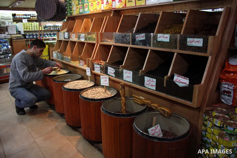 Palestinians display their goods at a food store in the West Bank city of Hebron on January 13, 2011. Photo by Najeh Hashlamoun