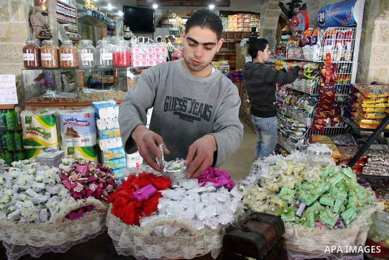 Palestinians display their goods at a food store in the West Bank city of Hebron on January 13, 2011. Photo by Najeh Hashlamoun