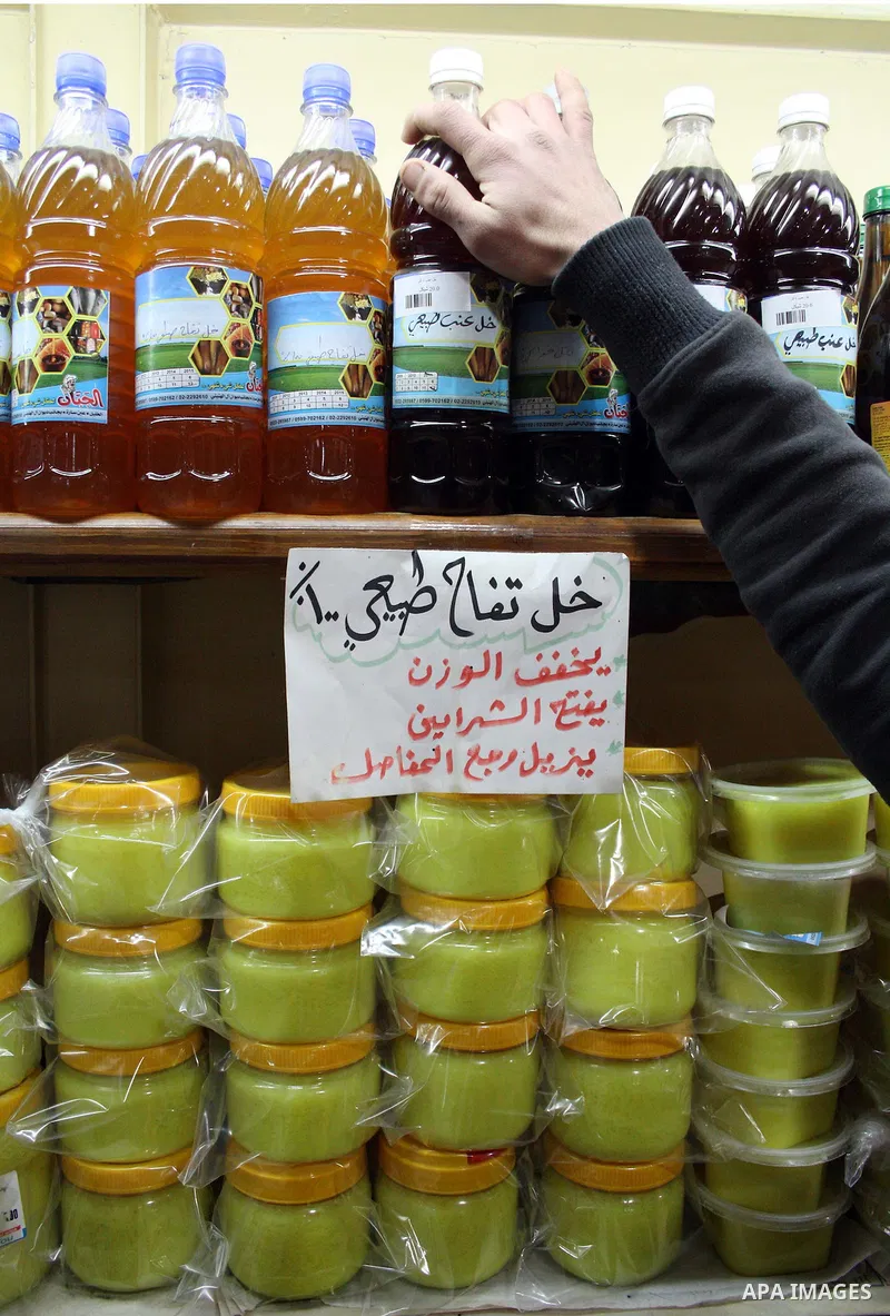 Palestinians display their goods at a food store in the West Bank city of Hebron on January 13, 2011. Photo by Najeh Hashlamoun