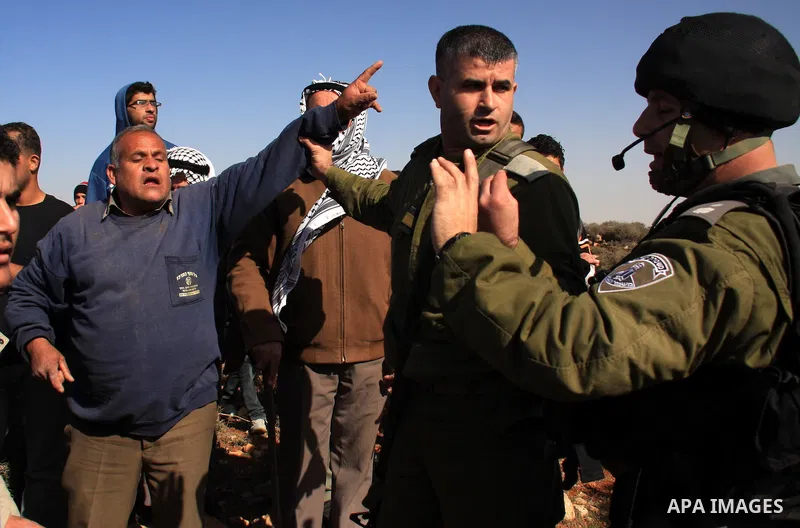 Israeli soldiers scuffle with Palestinians during a clash between Jewish settlers and Palestinians over farming land between the Jewish settlement Shiloh and the West Bank the village of Qusrah near Nablus, Thursday, Jan...