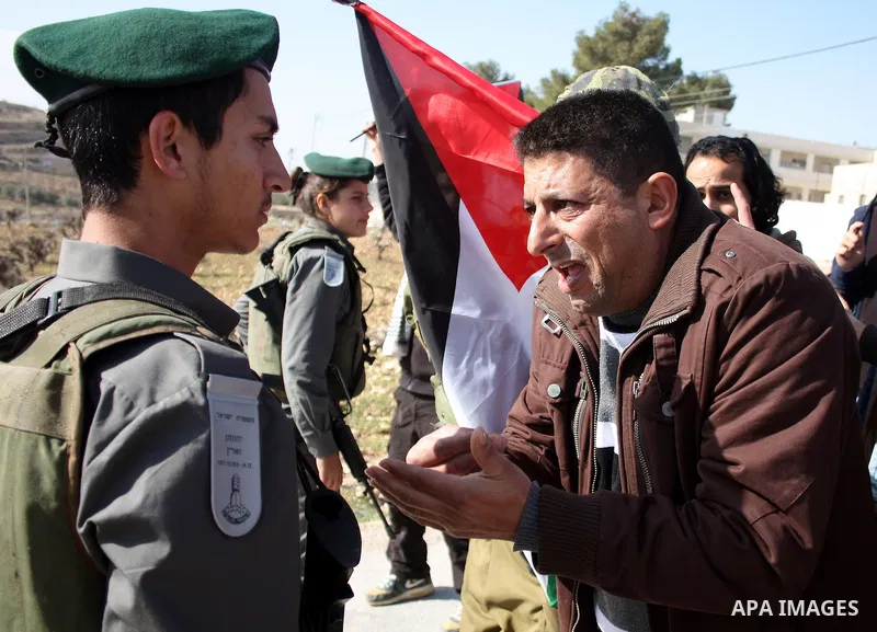 Israeli soldiers scuffle with Palestinian, Israeli and foreign protesters during a demonstration against Israel's controversial separation barrier in the West Bank village of Maasarah, near Bethlehem, on January 14, 2011...
