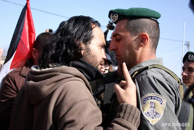 Israeli soldiers scuffle with Palestinian, Israeli and foreign protesters during a demonstration against Israel's controversial separation barrier in the West Bank village of Maasarah, near Bethlehem, on January 14, 2011...
