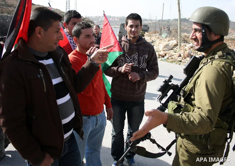 Israeli soldiers scuffle with Palestinian, Israeli and foreign protesters during a demonstration against Israel's controversial separation barrier in the West Bank village of Maasarah, near Bethlehem, on January 14, 2011...