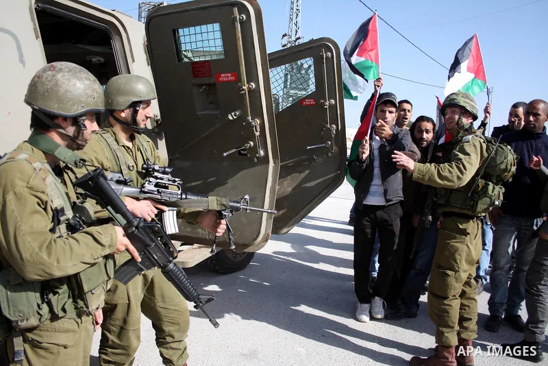 Israeli soldiers scuffle with Palestinian, Israeli and foreign protesters during a demonstration against Israel's controversial separation barrier in the West Bank village of Maasarah, near Bethlehem, on January 14, 2011...