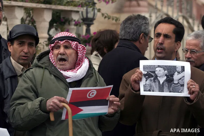 Palestinian demonstrators take part in a protest in solidarity with the Tunisian people in front of the Tunisian Embassy in the West Bank city of Ramallah January 15, 2011. The protest confirmed that the two peoples, Pal...