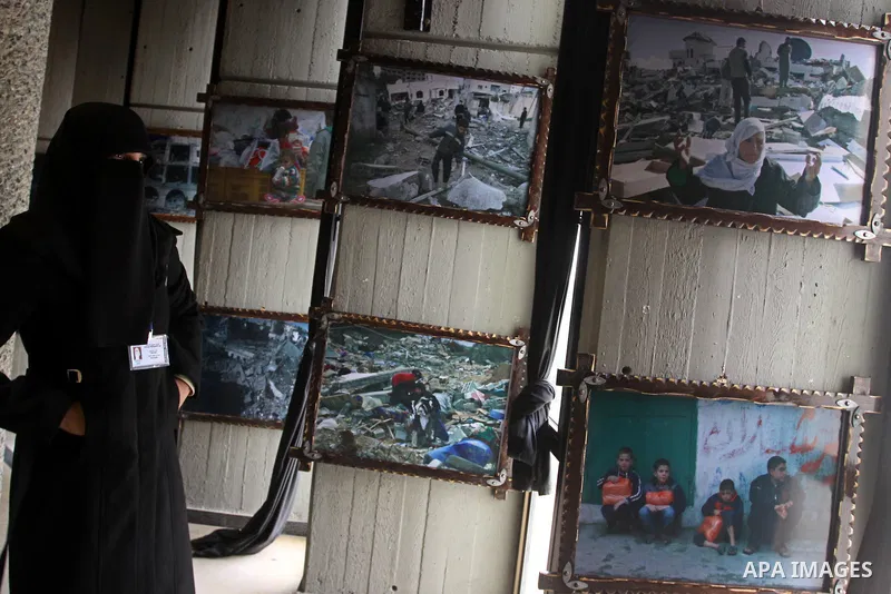 A Palestinian woman attends an exhibition organized by Palestinian High Commission marks the second anniversary of Israel's three-week offensive on Gaza, at al-Shawwa theatre, in Gaza city on Jan 16, 2011. Photo by Moham...