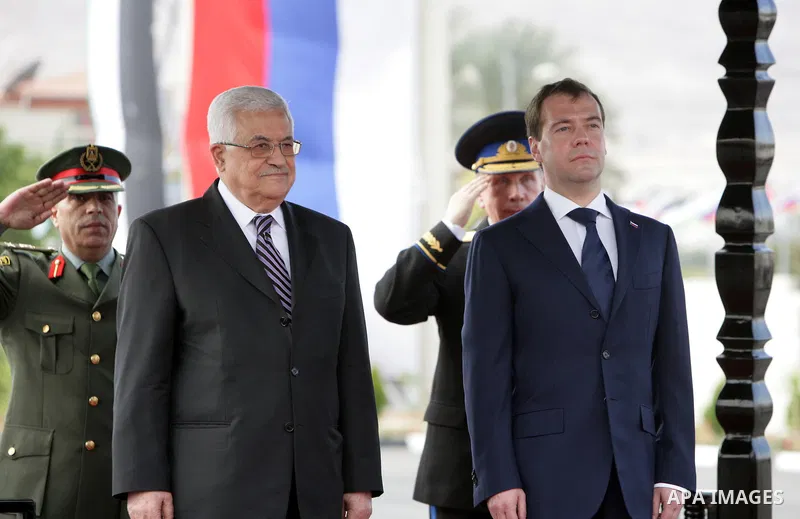 Palestinian President Mahmoud Abbas (L) and Russian President Dmitry Medvedev (R) review the Palestinian honor guard during Medvedev's visit to the West Bank City of Jericho, 18 January 2011. The president is scheduled t...