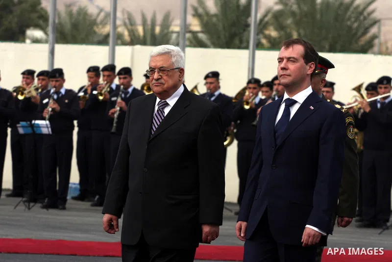 Palestinian President Mahmoud Abbas and Russian President Dmitry Medvedev review an honor guard prior to their meeting in the West Bank town of Jericho, Tuesday, Jan. 18, 2011. Medvedev arrived in the West Bank on Tuesda...