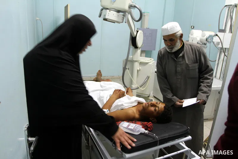A wounded Palestinian youth receives a treatment at a hospital in the northern Gaza Strip town of Beit Hanon on Jan. 18,2011. An Israeli shell killed a Palestinian and injured two other, Palestinian hospital official sai...