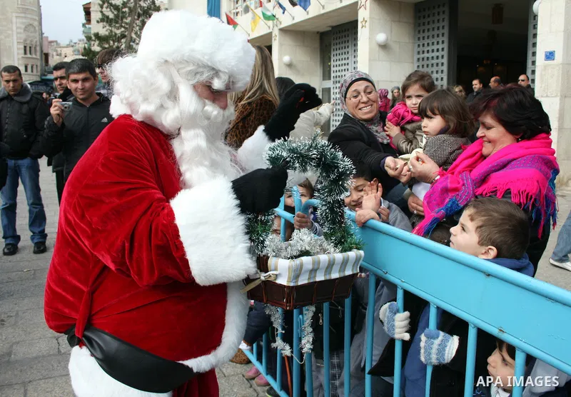 Orthodox Armenian take part in a procession outside the Church of the Nativity in the West Bank town of Bethlehem on Christmas Eve, January 18, 2011. While most Armenians celebrate Christmas on January 6th, the Orthodox...