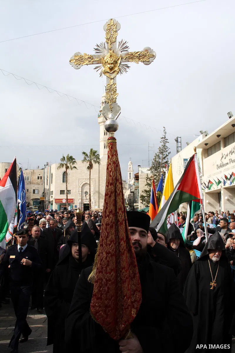 Orthodox Armenian take part in a procession outside the Church of the Nativity in the West Bank town of Bethlehem on Christmas Eve, January 18, 2011. While most Armenians celebrate Christmas on January 6th, the Orthodox...