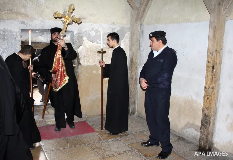 An Armenian Orthodox Christian priest enters the Church of the Nativity, which houses the biblical birth place of Jesus Christ, in the West Bank town of Bethlehem on January 18, 2011, to celebrate Christmas. While most A...