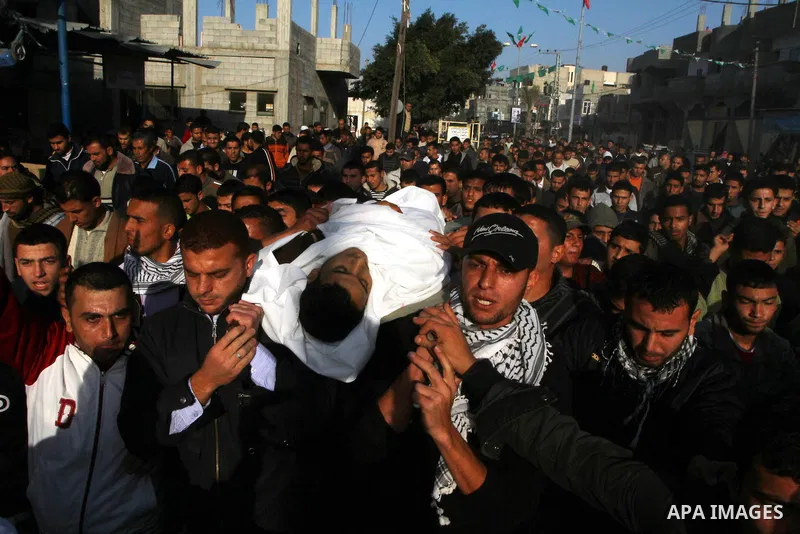 Palestinian mourners carry the body of Amjad al-Zaaneen, during his funeral in Beit Hanoun in the northern Gaza Strip, Tuesday, Jan. 18, 2011. A medical official in the Gaza Strip al-Zaaneen was killed and two others wou...
